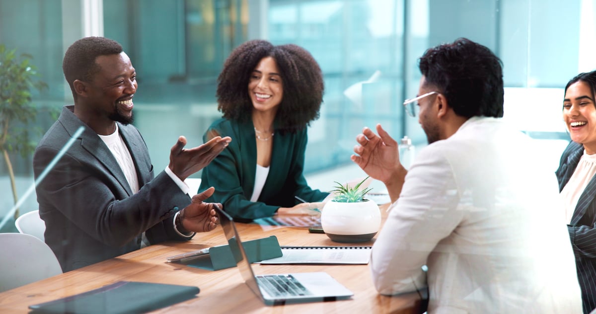 Two professionals in a modern office discussing business strategy and collaboration